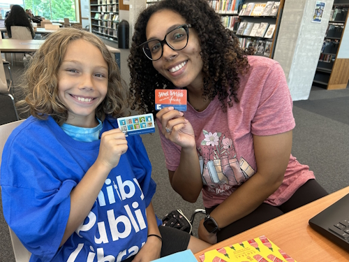 two people with library card